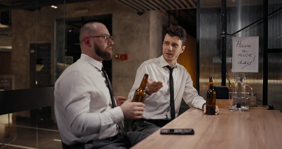 Colleagues enjoy drinks and lively discussion in a stylish bar setting during a lovely night out