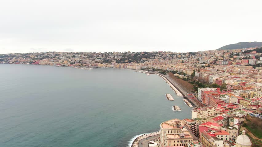 Panoramic drone view of Naples dense historic center and blue coastline in Italy