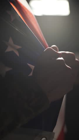 A soldier runs his hand over the American flag on Veterans Day.
