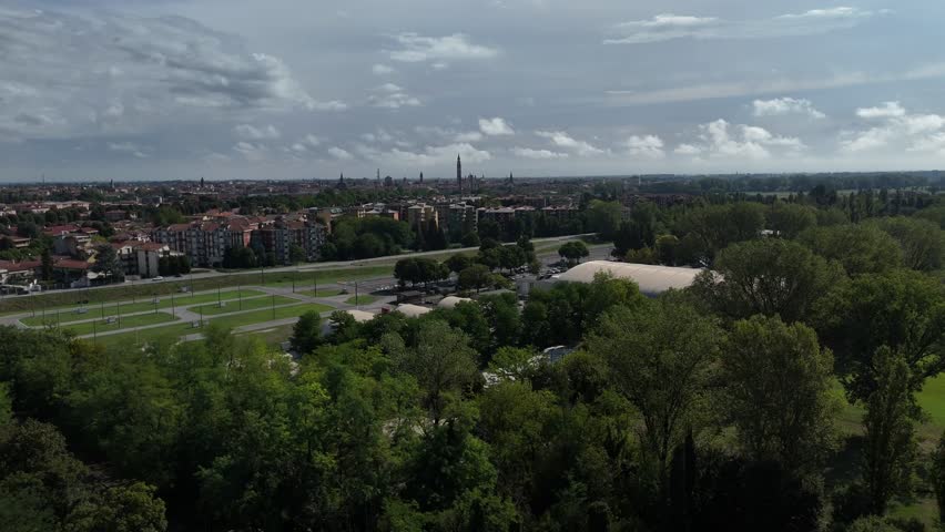 Aerial view of Cremona cityscape meeting countryside in Lombardy, northern Italy with Torrazzo bell tower in the background