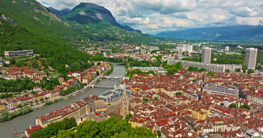 Aerial view of Grenoble. Panoramic view featuring the Isere river, urban landscape, mountains in the French Alps at summer