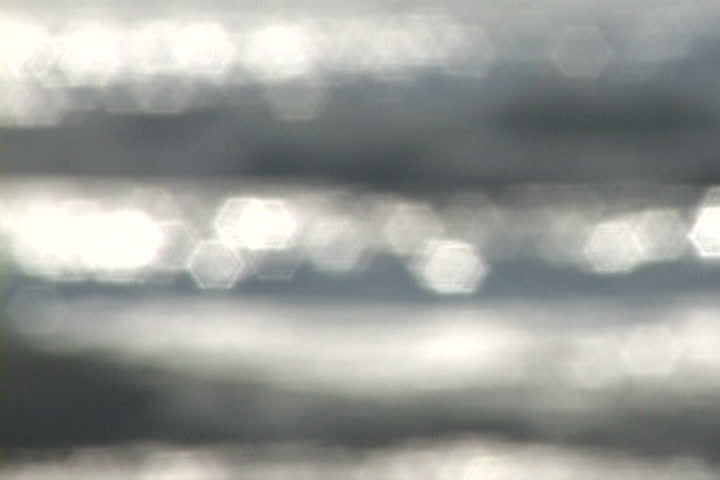 Background texture of waves in ocean reflecting with soft focus.