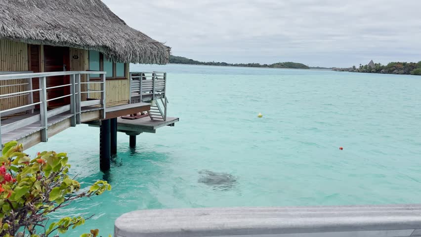 Summer Bora Bora Vacation Resort in French Polynesia with turquoise and aquamarine shallow lagoon clear water