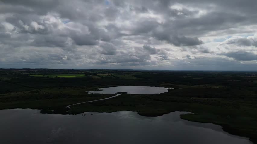 A cloudy sky over a lake and a river.