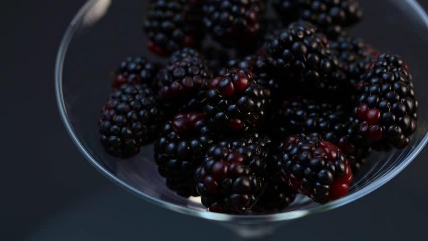 black berries rotating over gray backdrop, close-up. Macro shot. Market. Vegan food, macro shot 4k