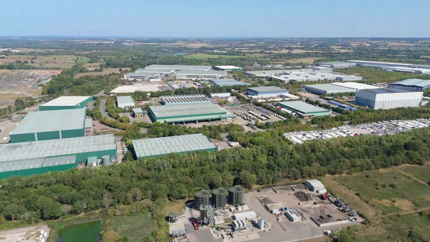 Aerial drone view of a massive logistics distribution centre and industrial business hub for manufacturing on the outskirts of Birmingham England UK