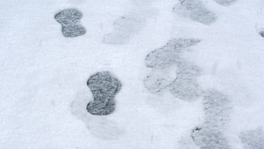 Winter scene. Snowy road and footprints.