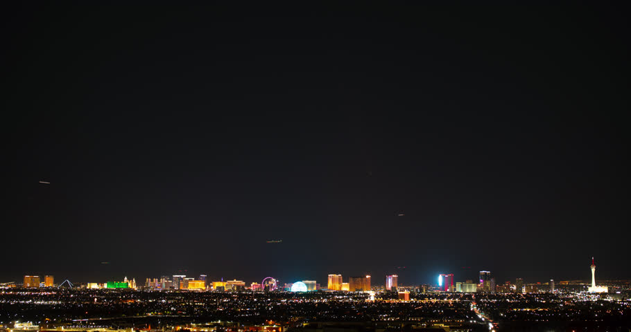 Las Vegas strip with inner city skyline with chaotic air traffic and a faint Comet Atlas.