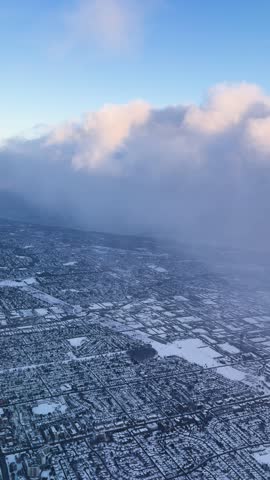 Aerial view of snowy Ontario cityscape under vast cloudy sky