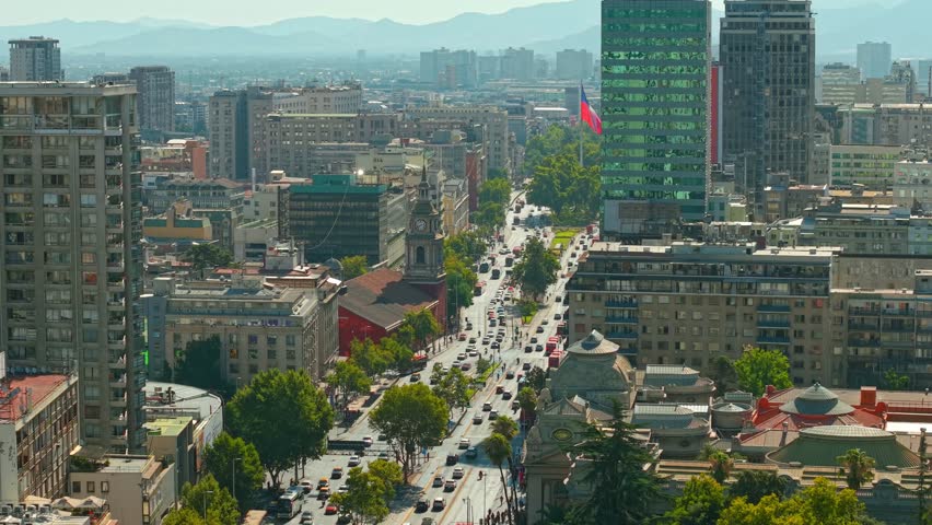 Aerial fly Chilean Flag Over Alameda Avenue and San Francisco Church in Santiago
