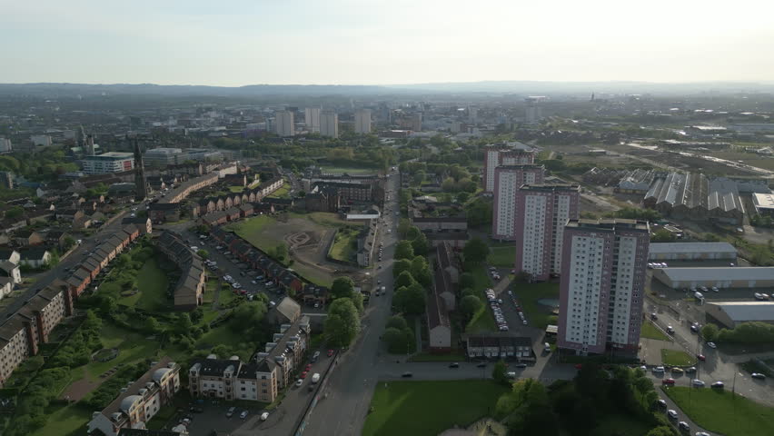 High angle aerial drone shot showing residential apartment blocks and urban housing in the Royston area of Glasgow, Scotland.