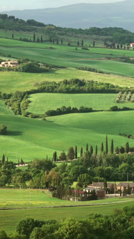 Shadows of clouds slide on the hills of Tuscany, Italy, timelapse. Vertical video