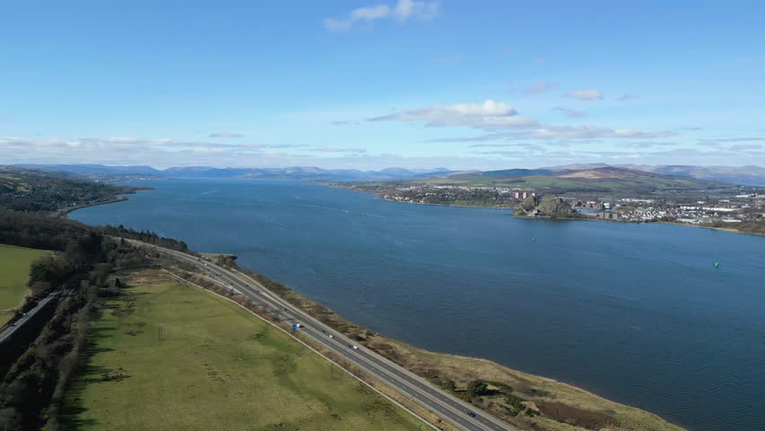 High altitude aerial shot showing the M8 motorway running parallel to the River Clyde under a clear blue sky. Perfect for travel, infrastructure, and Scottish landscape projects.