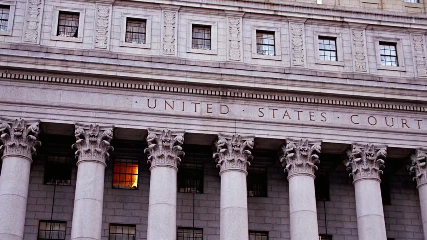 Exterior view of the United States courthouse building with classic columns and windows, representing justice, law, government authority, and legal system architecture.