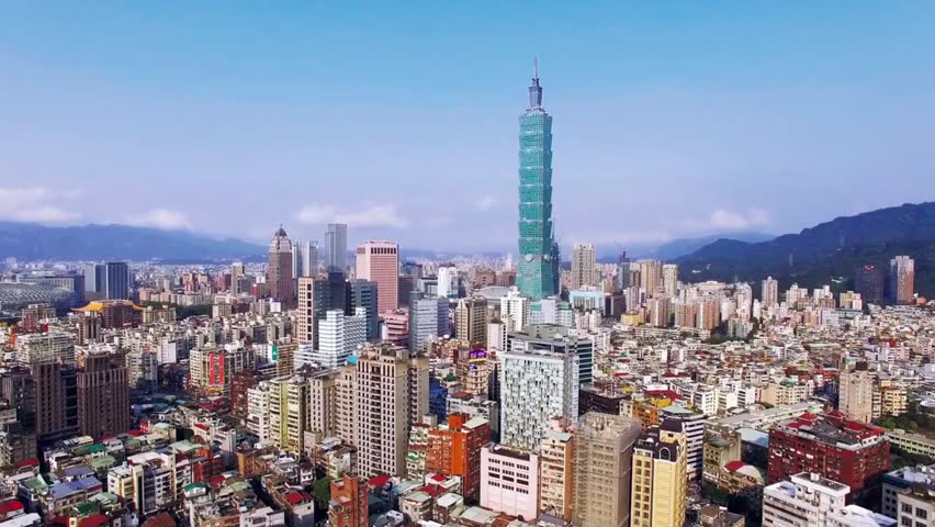 Aerial view of Taipei skyline featuring Taipei 101 under a clear blue sky, showcasing modern skyscrapers, urban landscape, and iconic architecture in Taiwan.