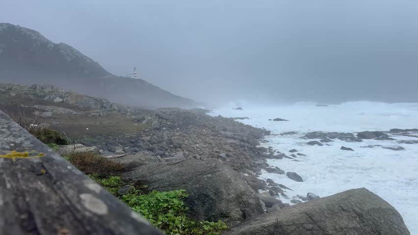 Cabo Silleiro lighthouse in Galicia with strong waves on a stormy day