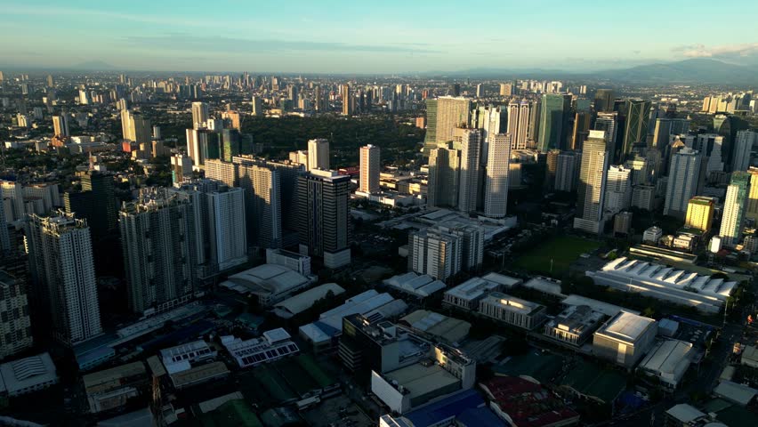 Bright daytime aerial of Manila skyline featuring dense buildings, urban grid, and clear atmosphere showcasing the capital’s modern scale.