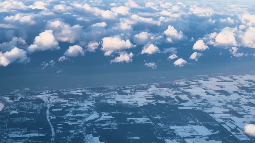 Aerial view of clouds over snowy Ontario landscape, serene and vast