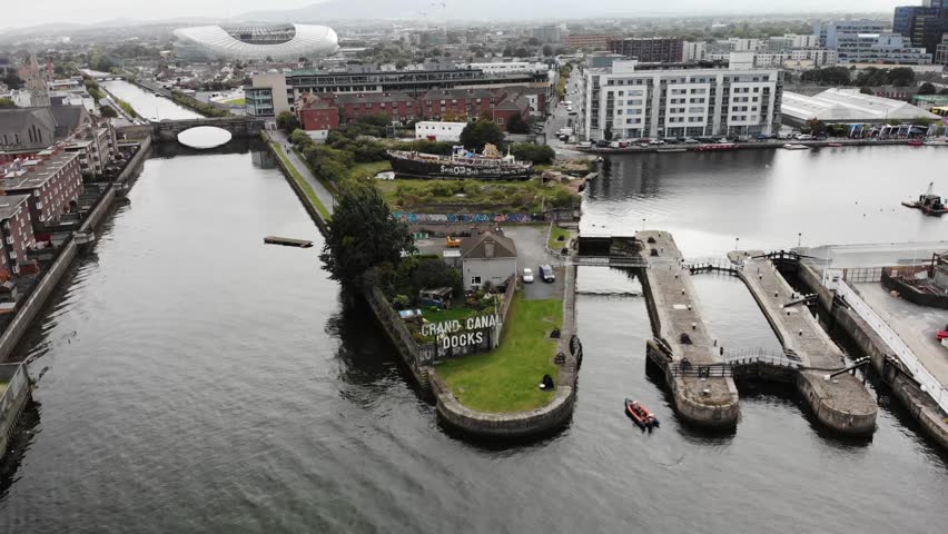 Grand Canal Dock in Dublin City, aerial pull back from the sign. Aviva Stadium and urban area.