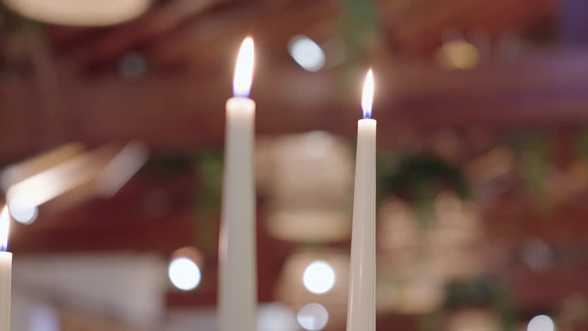 Close-up of candle flames creating cozy ambient light indoors