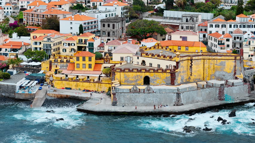 Aerial view of Fortaleza de Sao Tiago on the coastline of Funchal, Madeira Island, Portugal. Historic seaside fortress and urban waterfront
