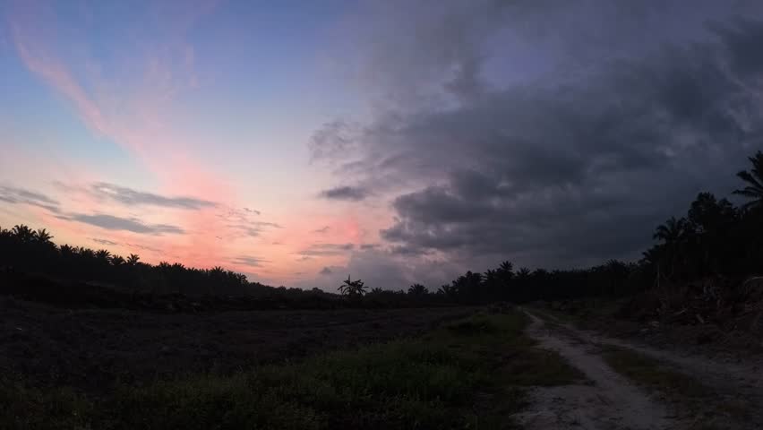 Time lapse footage of the colorful moving sky at the meadow farm.