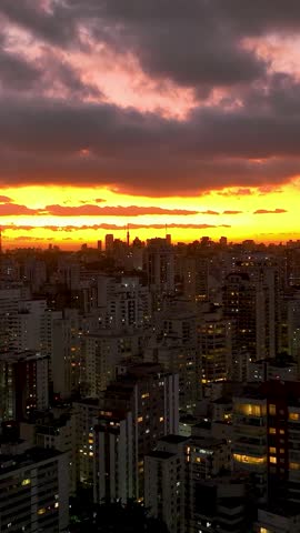Sunset at Sao Paulo Brazil. Cityscape of sunset sky at city Sao Paulo Brazil. Scenic landscape of colorful sky and illuminated towers offices buildings and skyscrapers. Urban life scenery.