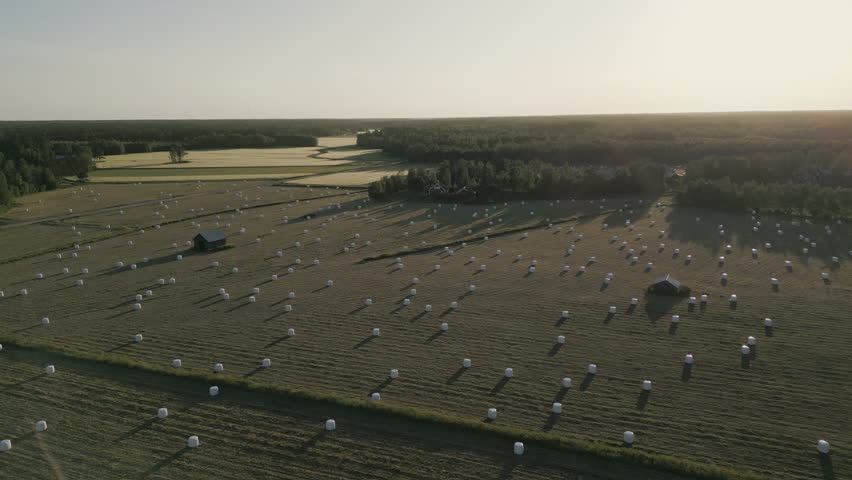 Helicopter view of Scandinavian country side, fields of hay bales