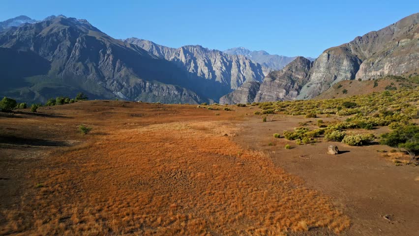 Forward motion blur with tilt down revealing arid valley. Cajón del Maipo, Chile