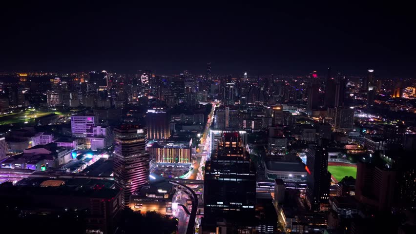 Aerial view Thailand, Night cityscape of Bangkok with modern skyscrapers and road traffic.