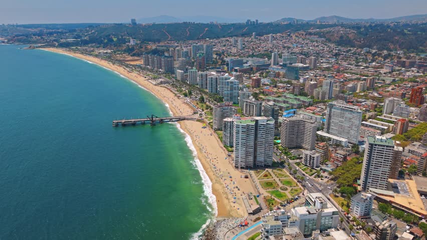 Panoramic aerial view of Viña del Mar with the Vergara Pier on a sunny day, showing the infrastructure along the seashore, Chile
