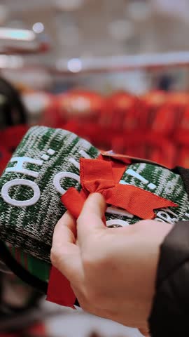 Christmas gift. Christmas shopping, decorations. Fair. festive accessories. close-up. woman chooses Christmas gift set, warm green socks and slippers, in the shop. Merry Christmas and Happy New Year. 