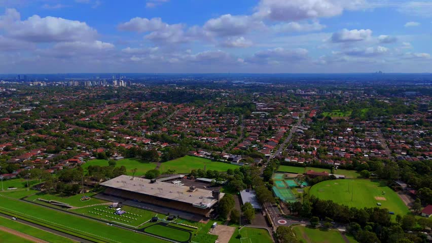 Drone panoramic aerial view of Sydney NSW Australia city Skyline and looking down on roof tops streets roads trees and parks in Suburban Sydney inner west suburbs of Burwood Ashfield Croydon Summer Hill Canterbury Marrickville 