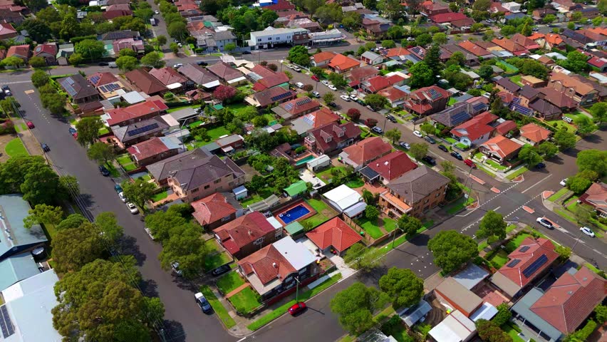 Drone panoramic aerial view of Sydney NSW Australia city Skyline and looking down on roof tops streets roads trees and parks in Suburban Sydney inner west suburbs of Burwood Ashfield Croydon Summer Hill Canterbury Marrickville 