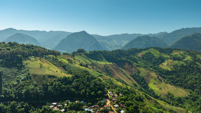 Drone landscape of a floating road in Nan Province, Thailand, stretching across mountain ridges and valleys, creating a scenic sky highway above the highland terrain.