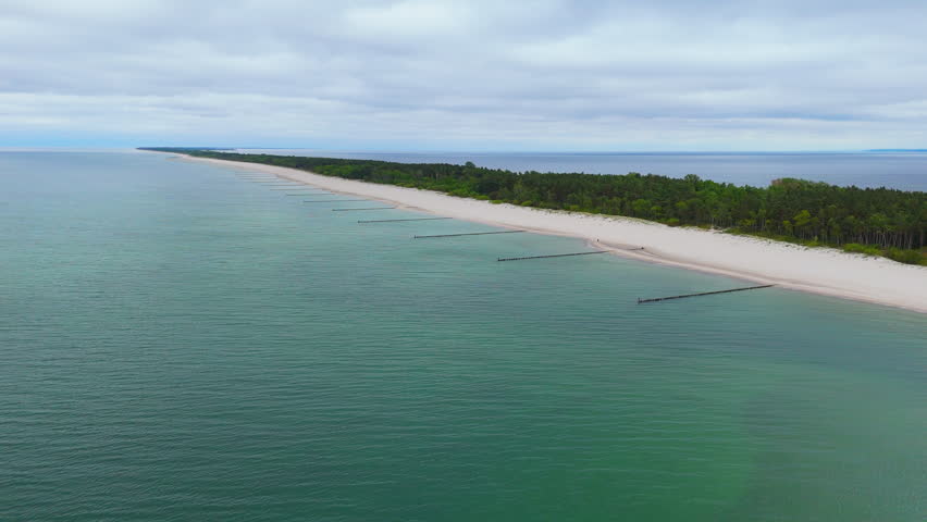 Explore the empty beach and calm waters of Lake Michigan on a cloudy day