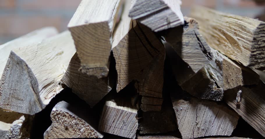Chopped firewood is piled in a woodshed. Harvesting firewood for the winter for a solid fuel boiler. Video with sound