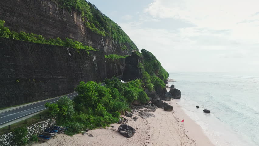 Drone view of tropical coastal landscape with ocean waves, beach coastline