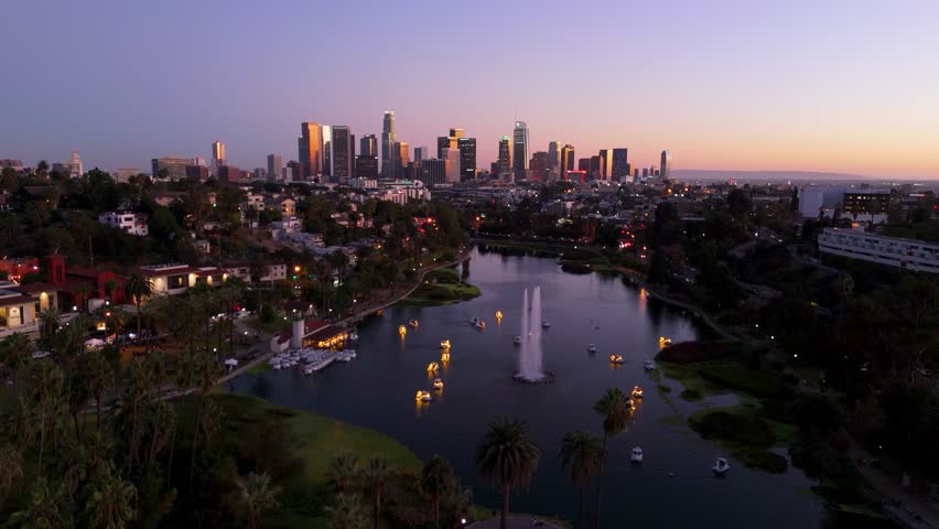 Aerial view of downtown Los Angeles skyline and Echo Park Lake at sunset