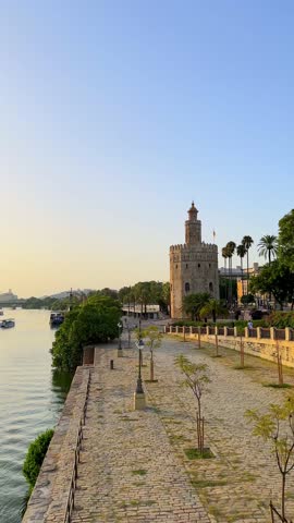 Beautiful sunset view of the Torre del Oro and the river promenade in Seville, Andalusia, Spain
