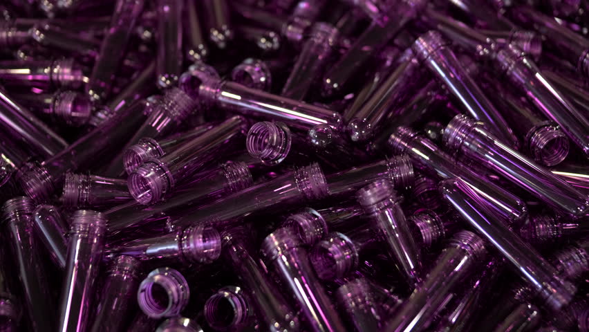 Purple PET preforms for plastic bottle manufacturing process.