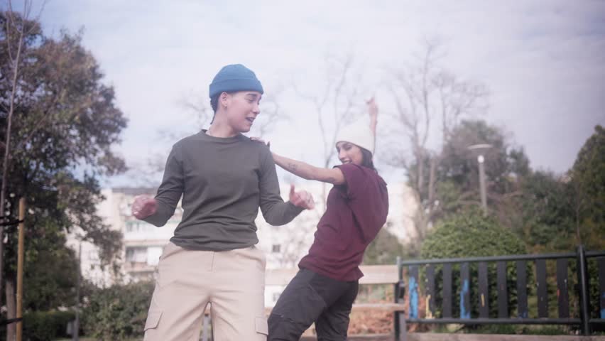 Urban dancer and beatboxer performing hip hop freestyle in a park