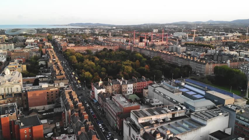 Merrion Square City Park and Dublin cityscape, Aviva Stadium and coastal on horizon. Drone