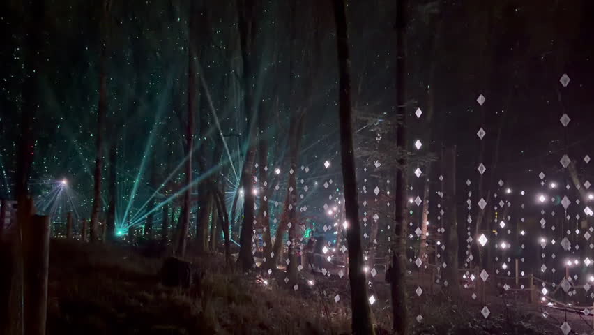 Artistic laser light show in trees of Longford Forest Parc in Ireland