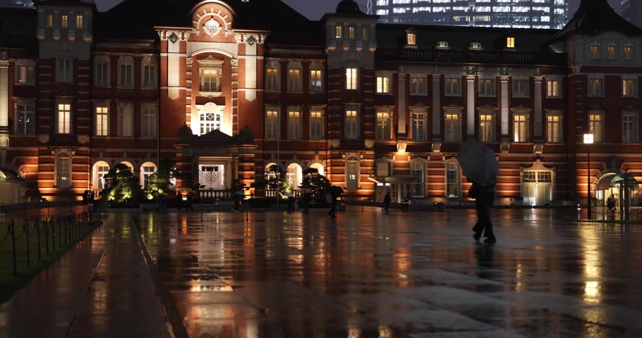A night cityscape of the rainy urban street at the business town in Tokyo