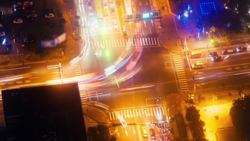 Time-lapse of city traffic at night, capturing blurred lights and motion, ideal for urban, cityscape, and night visuals.