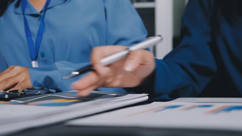 Auditor and accountant team working in office, analyze financial data and accounting record with calculator. Accounting company provide finance and taxation planning for profitable cash flow