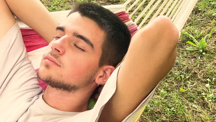 young man sleeping or resting in the summer in the hammock