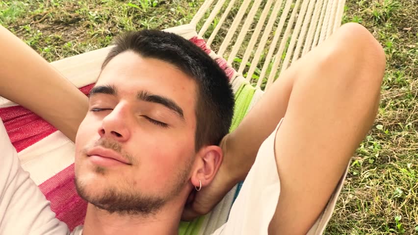 young man sleeping or resting in the summer in the hammock
