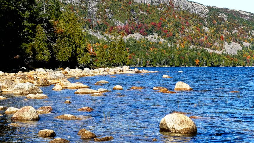 Jordan pond showing stunning fall foliage on the Bubbles mountains in Acadia national park, Maine